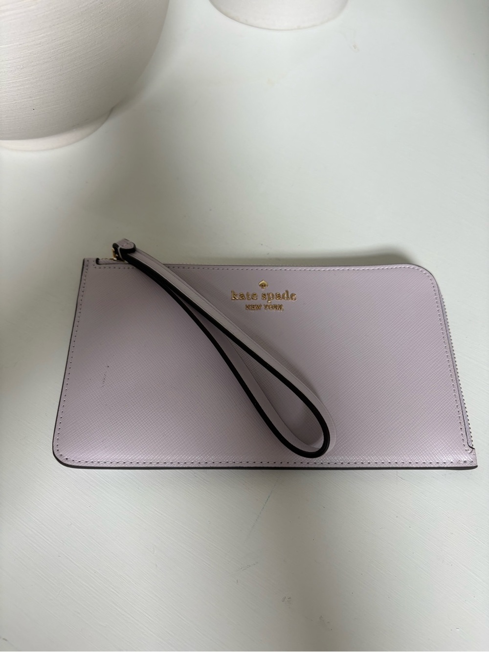 kate spade pastel lilac wristlet with gold logo